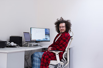 Image showing graphic designer in bathrobe working at home