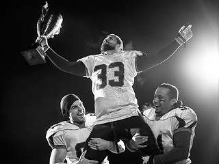 Image showing american football team with trophy celebrating victory