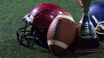 Image showing closeup of american football,helmets and trophy