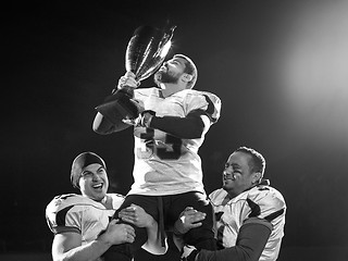 Image showing american football team with trophy celebrating victory