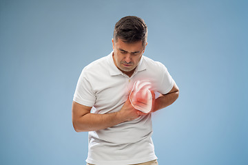 Image showing unhappy man having heart attack or heartache