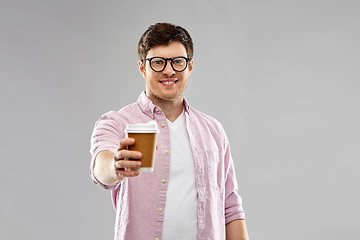 Image showing young man or student in glasses drinking coffee