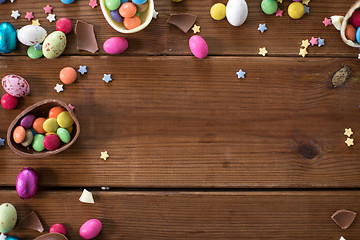 Image showing chocolate eggs and candy drops on wooden table