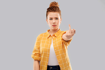 Image showing red haired teenage girl showing middle finger