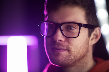 Image showing portrait of man in glasses over neon lights