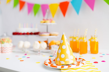 Image showing party caps, food and drinks on birthday