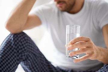 Image showing close up of sick man with glass of water