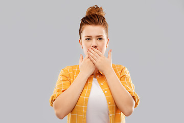 Image showing red haired teenage girl covering mouth by hands