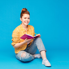 Image showing happy teenage student girl with diary or notebook