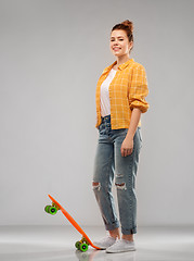 Image showing red haired teenage girl with short skateboard