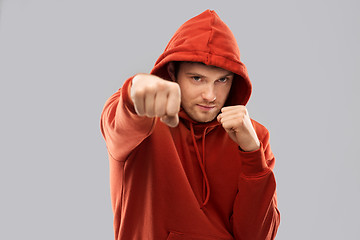 Image showing man in red hoodie fighting with fists or boxing