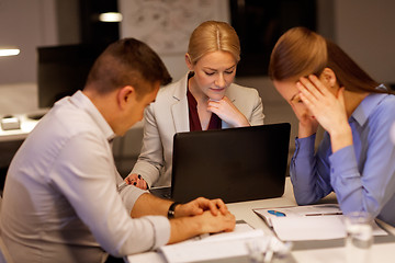 Image showing business team with laptop working at night office