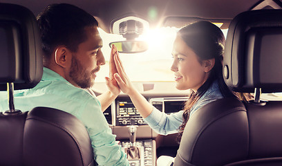 Image showing happy man and woman driving in car