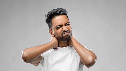 Image showing tired indian man suffering from neck pain