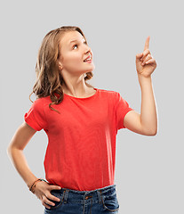 Image showing smiling teenage girl pointing finger to something