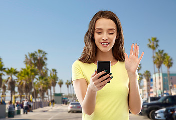 Image showing smiling teenage girl having video call smartphone