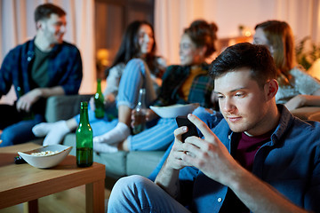 Image showing man with smartphone at home party