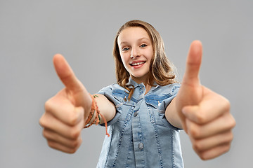 Image showing smiling teenage girl showing thumbs up