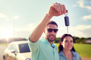 Image showing happy man and woman with car key outdoors