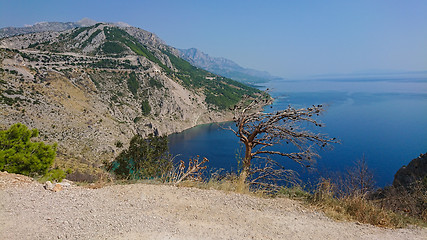 Image showing Rocky beach, bue transparent sea