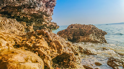 Image showing Rocky beach, bue transparent sea