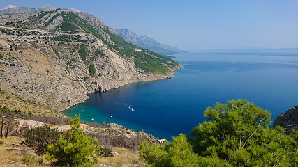 Image showing Rocky beach, bue transparent sea