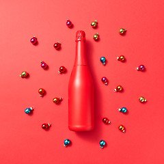 Image showing Holiday composition red painted mockup bottle on a Christmac background.