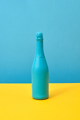 Image showing Blue painted holiday mockup bottle on a duotone background.