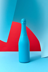 Image showing Holiday wine mock-up bottle painted blue with soft shadows.