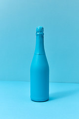 Image showing Holiday champagne mock up bottle painted blue with soft shadows.