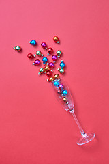 Image showing Colorful Christmas balls in a glass as a champagne drink bubbles.