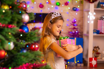 Image showing Beautiful ten-year-old girl received a gift from Santa Claus