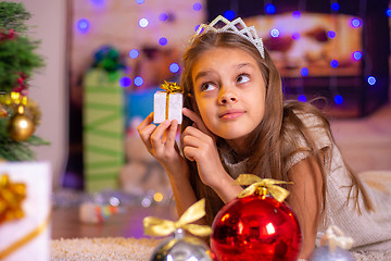 Image showing Girl holding a small pretty gift in her hands