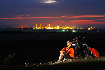 Image showing guy has a rest sitting near his bike