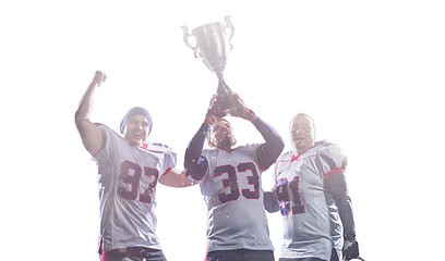 Image showing american football team with trophy celebrating victory