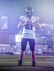 Image showing portrait of confident American football player standing on the f