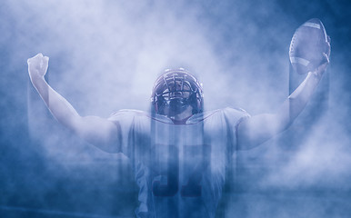 Image showing american football player celebrating after scoring a touchdown