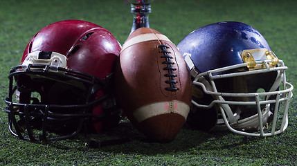 Image showing closeup of american football,helmets and trophy