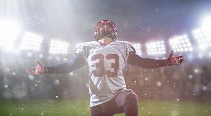 Image showing american football player celebrating after scoring a touchdown