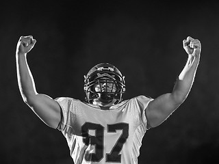 Image showing american football player celebrating after scoring a touchdown