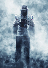 Image showing portrait of confident American football player standing on the f