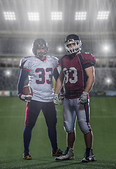 Image showing Two American football players standing  on the field