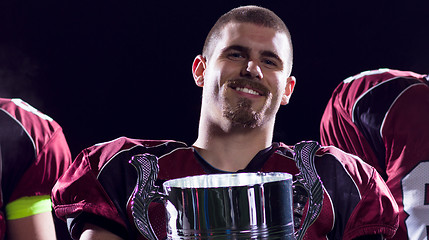 Image showing american football team with trophy celebrating victory