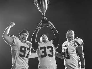 Image showing american football team with trophy celebrating victory