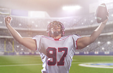 Image showing american football player celebrating after scoring a touchdown