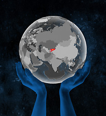 Image showing Kyrgyzstan on globe in hands in space