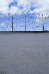 Image showing Prison wall and wire fence