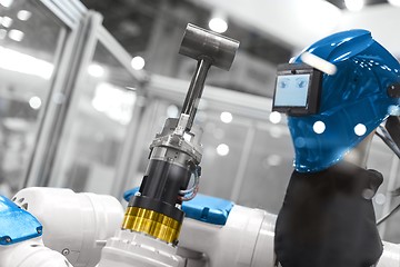 Image showing Automatic robot arm working in industrial environment