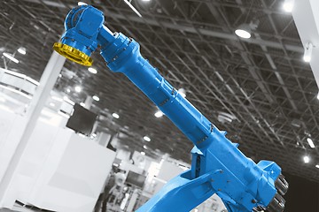Image showing Automatic robot arm working in industrial environment