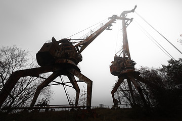 Image showing Rusty old industrial dock cranes at the Dock